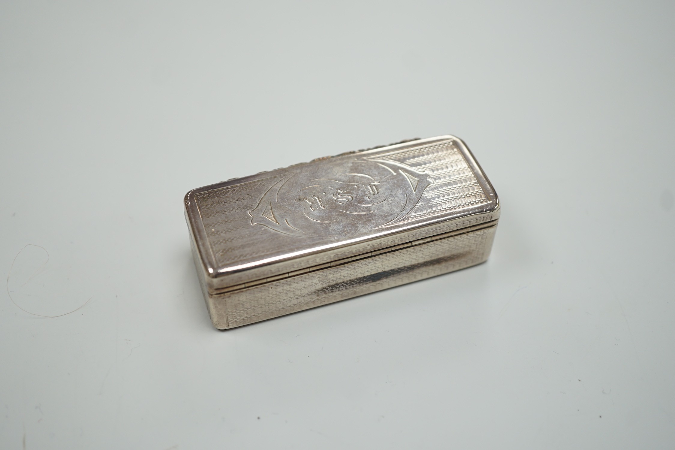 An early Victorian engine turned silver rectangular snuff box, Edward Smith, Birmingham, 1843, 77mm, with engraved initials.